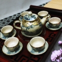Bộ ấm trà dáng quả hồng bọc đồng (Men rạn)
